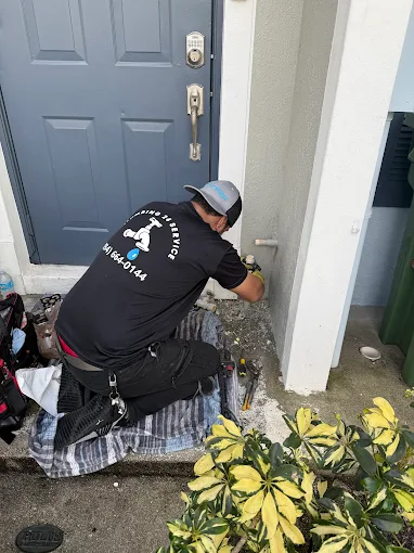 Plumbing 24 Service plumber servicing exterior water heater in Broward County